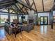 Spacious living room boasts wood floors, stone fireplace, vaulted ceilings, and large windows with scenic views at 2004 Layton Rd, Anderson, IN 46011