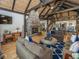 Inviting living room featuring a stone fireplace, vaulted ceilings, hardwood floors, and open access to dining area at 2004 Layton Rd, Anderson, IN 46011