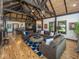 Expansive living area showcasing a stone fireplace, vaulted ceilings, hardwood floors, and a view to dining area at 2004 Layton Rd, Anderson, IN 46011