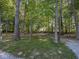 Wooded property with mature trees and lush greenery, providing privacy and tranquility at 2004 Layton Rd, Anderson, IN 46011