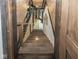 Staircase featuring natural hardwood steps, an accent light fixture, and open floor design at 2004 Layton Rd, Anderson, IN 46011