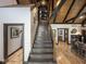 Elegant staircase featuring wood treads, black iron railing, and open views of the living spaces at 2004 Layton Rd, Anderson, IN 46011
