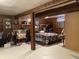 Finished basement used as bedroom features wood paneling and a bed with colorful bedding at 2032 N Auburn St, Speedway, IN 46224