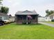Charming single-story home featuring a brick front porch with a well-manicured lawn at 2032 N Auburn St, Speedway, IN 46224