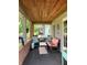 Cozy front porch featuring comfortable seating, a small table, and charming decor at 2032 N Auburn St, Speedway, IN 46224