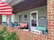 Inviting front porch with brick accents, outdoor seating, and decorative elements at 2032 N Auburn St, Speedway, IN 46224