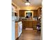Traditional kitchen with wooden cabinets, white appliances, and wood-look flooring at 2032 N Auburn St, Speedway, IN 46224