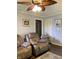 Spacious living room featuring recliners, ceiling fan, and warm lighting at 2032 N Auburn St, Speedway, IN 46224
