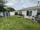 Backyard with lawn, bird feeder, and outdoor patio furniture at 2302 Rolling Oak Dr, Indianapolis, IN 46214