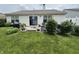 Spacious backyard featuring a patio, garden area, and lush green lawn at 2302 Rolling Oak Dr, Indianapolis, IN 46214