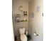Half bath with beach themed decor, toilet, and tiled flooring at 2302 Rolling Oak Dr, Indianapolis, IN 46214
