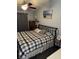 Bedroom featuring a wrought iron bed frame, ceiling fan, and neutral-toned decor at 2302 Rolling Oak Dr, Indianapolis, IN 46214