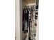 Neatly organized closet with hanging clothes and storage shelves at 2302 Rolling Oak Dr, Indianapolis, IN 46214