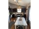 Eat-in kitchen features modern cabinets, stainless appliances, and a long dining table at 2302 Rolling Oak Dr, Indianapolis, IN 46214