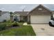 Inviting brick home featuring a lush front yard with flower beds at 2302 Rolling Oak Dr, Indianapolis, IN 46214
