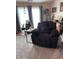 Cozy living room with an oversized recliner, stylish decor, and natural light at 2302 Rolling Oak Dr, Indianapolis, IN 46214