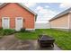 Backyard featuring a well maintained yard, a fire pit, privacy fence and exterior doors at 2326 N Pennsylvania St # 6, Indianapolis, IN 46205