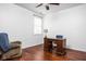 Bright bedroom featuring a ceiling fan, wood floors, and a desk by the window at 2326 N Pennsylvania St # 6, Indianapolis, IN 46205