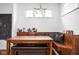 Bright breakfast nook featuring a wooden table, cushioned bench, and window view at 2326 N Pennsylvania St # 6, Indianapolis, IN 46205