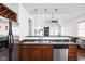 Open-concept kitchen with a stainless steel refrigerator and view into the Gathering room at 2326 N Pennsylvania St # 6, Indianapolis, IN 46205