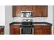 Kitchen with stainless steel appliances, granite countertops, and cherry cabinets at 2326 N Pennsylvania St # 6, Indianapolis, IN 46205