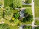An aerial view showcases a home with a well-maintained roof and lush landscaping at 233 Saddlebrook Dr, Zionsville, IN 46077
