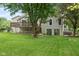 Backyard view with mature trees, a deck, and sliding glass doors, blending indoor and outdoor living spaces at 233 Saddlebrook Dr, Zionsville, IN 46077