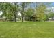 Picturesque backyard featuring a lush lawn, mature trees, and a fenced area, providing privacy and space to relax at 233 Saddlebrook Dr, Zionsville, IN 46077