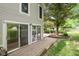 Back exterior view with sliding glass doors leading to a brick patio at 233 Saddlebrook Dr, Zionsville, IN 46077