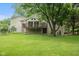 Backyard showcasing a spacious lawn, mature trees, and a deck, ideal for outdoor enjoyment and entertaining at 233 Saddlebrook Dr, Zionsville, IN 46077