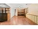 Finished basement featuring built-in shelving, hardwood floors, and natural light from the window at 233 Saddlebrook Dr, Zionsville, IN 46077