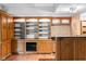 Basement with custom built-in shelving and cabinets, plus a wet bar for refreshments at 233 Saddlebrook Dr, Zionsville, IN 46077