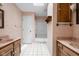 Well-lit bathroom featuring double sink vanity, shower-tub combo, and tile flooring at 233 Saddlebrook Dr, Zionsville, IN 46077