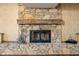 Stone fireplace with a wooden mantle creates a cozy focal point in this home at 233 Saddlebrook Dr, Zionsville, IN 46077
