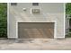 Attached two-car garage featuring a neutral door color and classic design, seamlessly integrating with the home's exterior at 233 Saddlebrook Dr, Zionsville, IN 46077