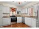 Bright kitchen with white cabinets, stainless steel appliances, and granite countertops offers modern convenience at 233 Saddlebrook Dr, Zionsville, IN 46077