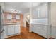 Open kitchen with white cabinetry and granite countertops leading to dining area and staircase at 233 Saddlebrook Dr, Zionsville, IN 46077
