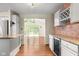 Bright kitchen view with stainless steel refrigerator, cabinets, and connection to living area and deck at 233 Saddlebrook Dr, Zionsville, IN 46077