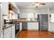 Bright kitchen with stainless steel appliances and hardwood floors at 233 Saddlebrook Dr, Zionsville, IN 46077