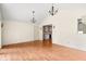 Bright living room featuring wood floors, adjacent dining area, and access to backyard at 233 Saddlebrook Dr, Zionsville, IN 46077