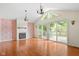 Bright, open living room with hardwood floors, vaulted ceilings, and sliding glass doors to outdoor deck at 233 Saddlebrook Dr, Zionsville, IN 46077