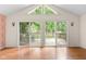Living room with sliding glass doors opening to a backyard deck, offering seamless indoor-outdoor living at 233 Saddlebrook Dr, Zionsville, IN 46077