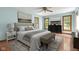 A main bedroom with wood floors, a ceiling fan, and a large window at 233 Saddlebrook Dr, Zionsville, IN 46077