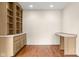 Home office with a built-in desk and shelving with hardwood floors at 233 Saddlebrook Dr, Zionsville, IN 46077