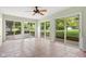 Bright sunroom with tile flooring and sliding glass doors opening to the backyard at 233 Saddlebrook Dr, Zionsville, IN 46077