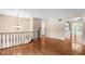 View of the stairway and railing looking towards the kitchen at 233 Saddlebrook Dr, Zionsville, IN 46077