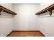Walk-in closet featuring wood floors and a double-rod closet system at 233 Saddlebrook Dr, Zionsville, IN 46077