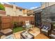 Cozy backyard patio with comfortable seating, turf, and an enclosed structure, perfect for relaxing outdoors at 2766 Del Prado Dr # 6, Indianapolis, IN 46227