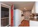 Well-lit kitchen featuring white cabinets, stone-style backsplash, and access to the garage and adjacent rooms at 2766 Del Prado Dr # 6, Indianapolis, IN 46227
