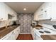 Functional kitchen with white cabinetry, dark countertops, and modern appliances, complemented by a unique backsplash design at 2766 Del Prado Dr # 6, Indianapolis, IN 46227